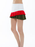 Front side view of model wearing the Courtside charm tennis skirt in white poppy and militare by inPhorm NYC