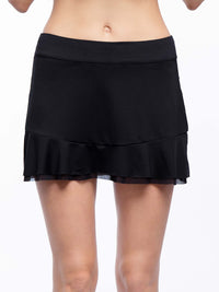 Front view of model wearing the Emma 13 1/2 " tennis skirt in black by inPhorm NYC