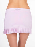 Back view of model wearing the Harper pleated skirt in ice pink and onyx by inPhorm NYC