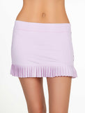 Front view of model wearing the Harper pleated skirt in ice pink and onyx by inPhorm NYC