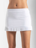 Front view of model wearing the Harper pleated skirt in white and onyx by inPhorm NYC