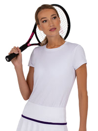 Front view of model wearing the sustainable Harper short sleeve crew neck in white by inPhorm NYC holding a tennis racket