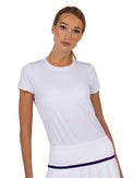 Front view of model wearing the sustainable Harper short sleeve crew neck in white by inPhorm NYC wearing a white skirt with her hands at her side