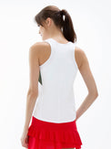 Back view of model wearing the In Motion color-blocked tank in white and militaire by inPhorm NYC with her hands in her pockets