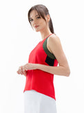 Side view of model wearing the In Motion tank in poppy and militare by inPhorm NYC with her arms bent at her waist