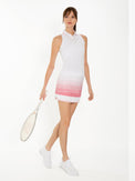 Front view of model wearing the Lilian 13 1/2" skirt in plumeria ombre by inPhorm NYC wearing white shoes and holding a tennis racket