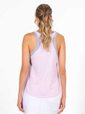 Back view of model wearing the Lilian tennis and active tank in ice pink combo by inPhorm NYC with her hands at her side