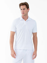 Front view of model wearing the performance mens classic tennis rib collar polo in white poppy and militare by inPhorm NYC with his hands at his side