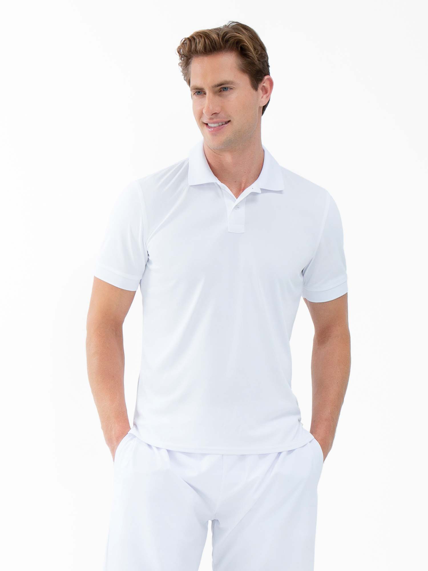 Front view of model wearing the performance mens classic tennis rib collar polo in white poppy and militare by inPhorm NYC with his hands in his pockets