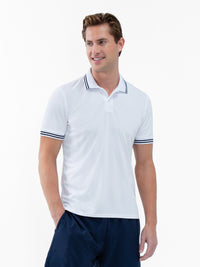 Front view of model wearing the mens classic tennis rib collar polo in white and midnight by inPhorm NYC with one hand in his pocket