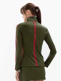 Back view of model wearing the motion knit jacket in militaire and poppy by inPhorm NYC with her hands at her side