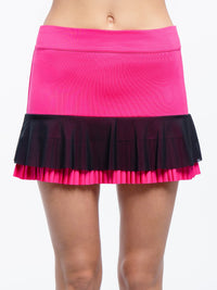 Front view of model wearing the Nora tennis pleated flounce skirt in fucshia and black by inPhorm NYC