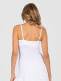 Back view of model wearing the Pearl adjustable strap tank in white by inPhorm NYC with her hands at her side