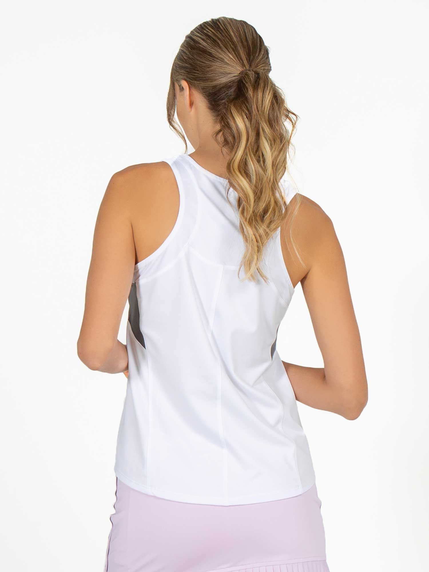 Back view of model wearing the Phoebe tennis and active tank in white and onyx by inPhorm NYC with her arms at her side