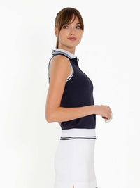 Side view of model wearing the Pheobe sleeveless polo in midnight and white by inPhorm NYC with her arms bent