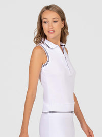 Front view of model wearing the Pheobe sleeveless polo in white and black by inPhorm NYC with her hands at her side