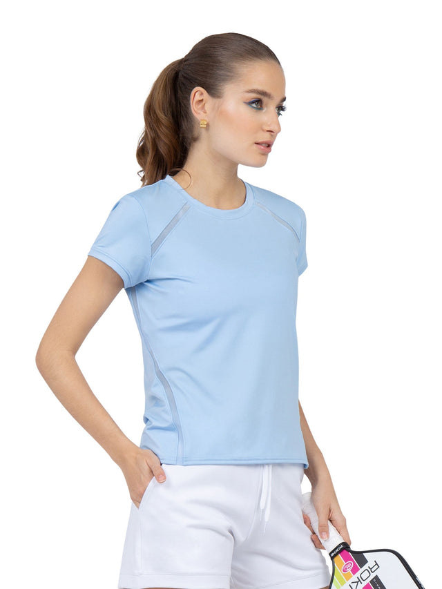 Front view of model wearing the classic short sleeve crew neck in bluebell by inPhorm NYC holding a tennis racket