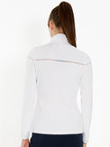 Back view of model wearing the Riley jacket in white by inPhorm NYC with her hands at her side