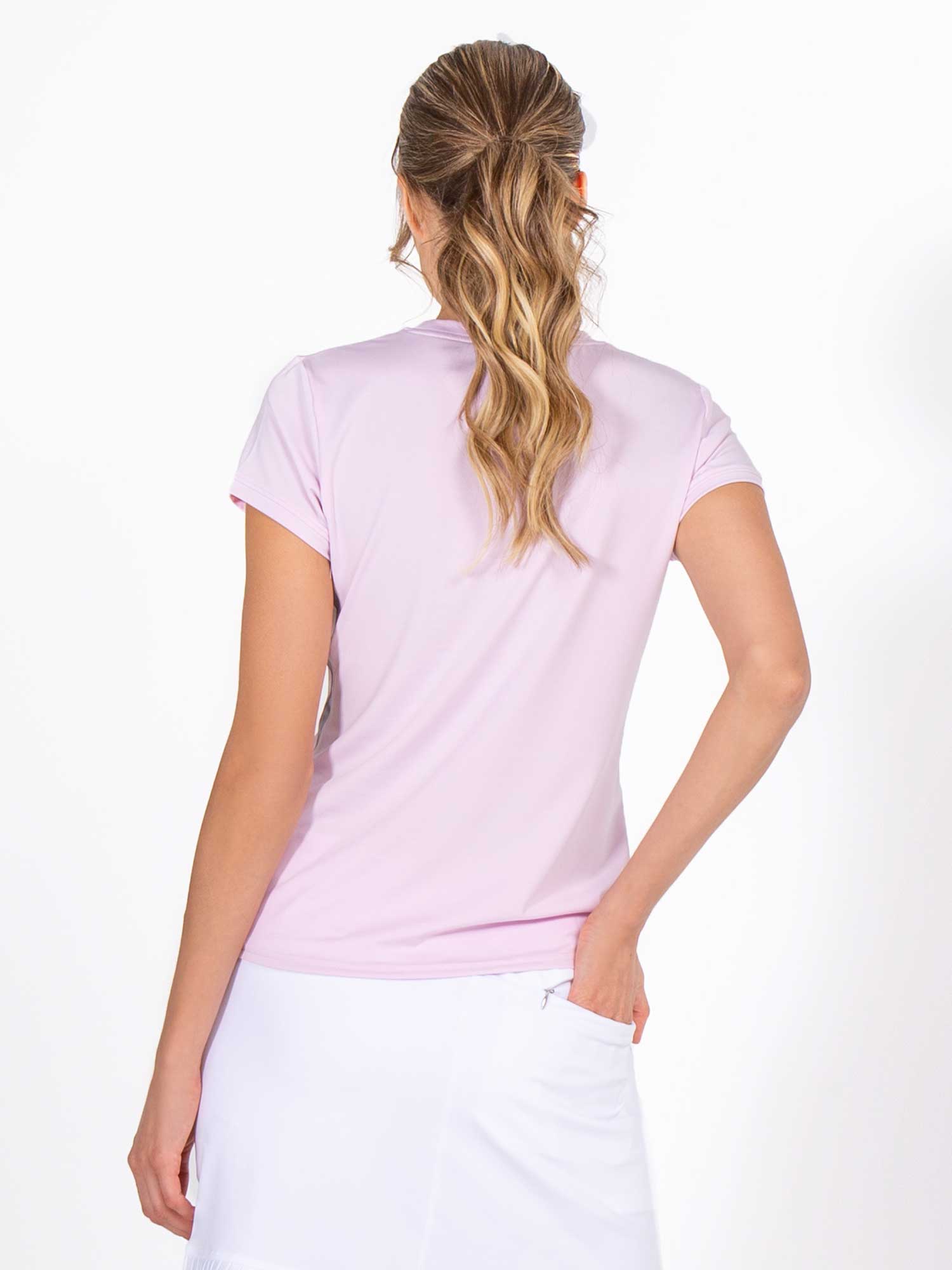 Back view of model wearing the classic short sleeve crew neck in ice pink by inPhorm NYC with one hand in her back pocket