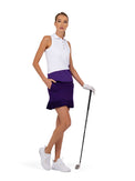 Front view of model wearing the Sinclaire 15" pleated golf and tennis skirt in imperial by inPhorm NYC holding a golf club