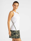 Side view of model wearing the spin active tennis tank in white and militaire by inPhorm NYC with her hands at her side