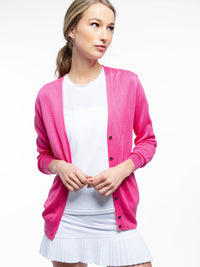 Front view of model wearing the classic cardigan v-neck sweater in pink rose by inPhorm NYC with her hands together