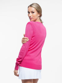 Back view of model wearing the classic cardigan v-neck sweater in pink rose by inPhorm NYC with her hand over her arm