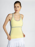 Front view of model wearing the Ashley racer tank in lemondae and pearl by inPhorm NYC wearing a white skirt